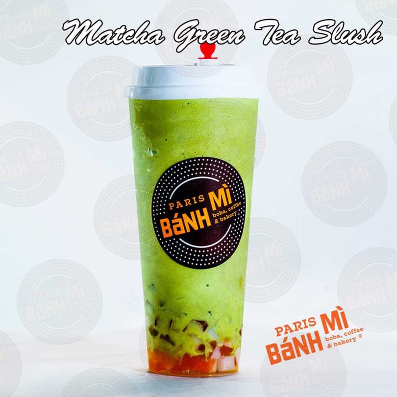 A Paris Banh Mi Matcha Green Tea Slush with colorful jellies and boba at the bottom.
