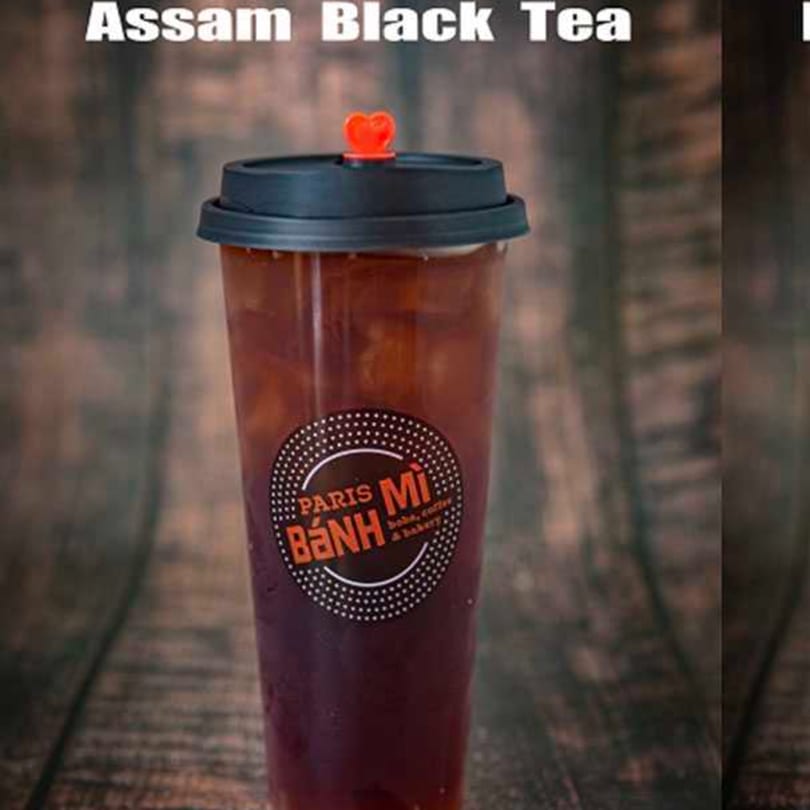 Assam Black Tea from Paris Banh Mi Augusta LLC, a Vietnamese restaurant, in a clear plastic cup.